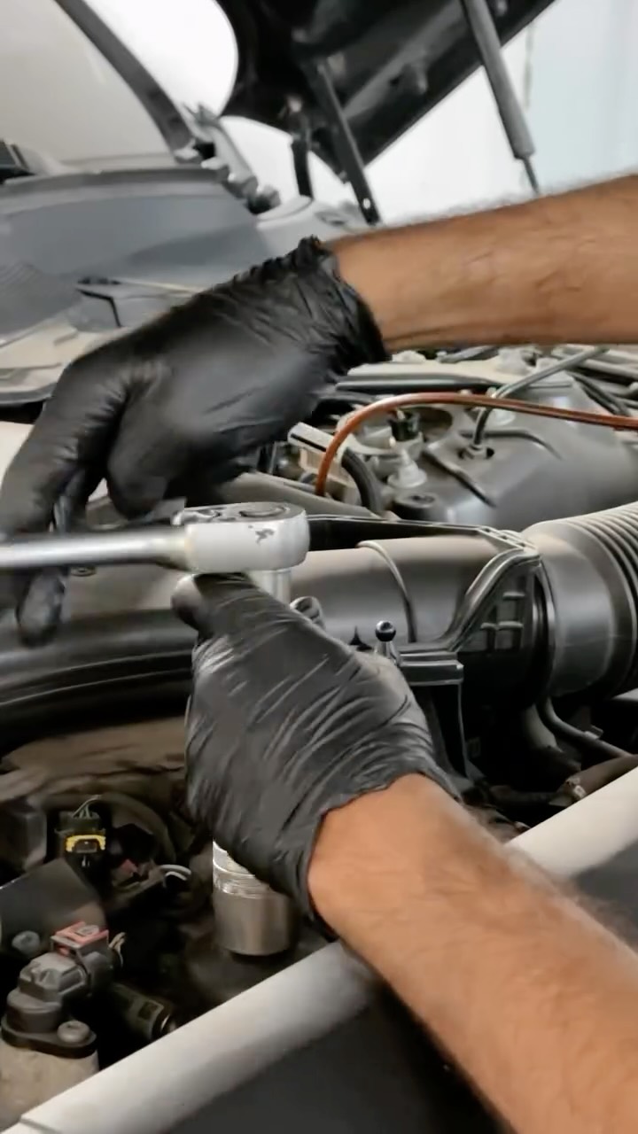 A Jbeily Land Rover technician inspecting a vehicle engine